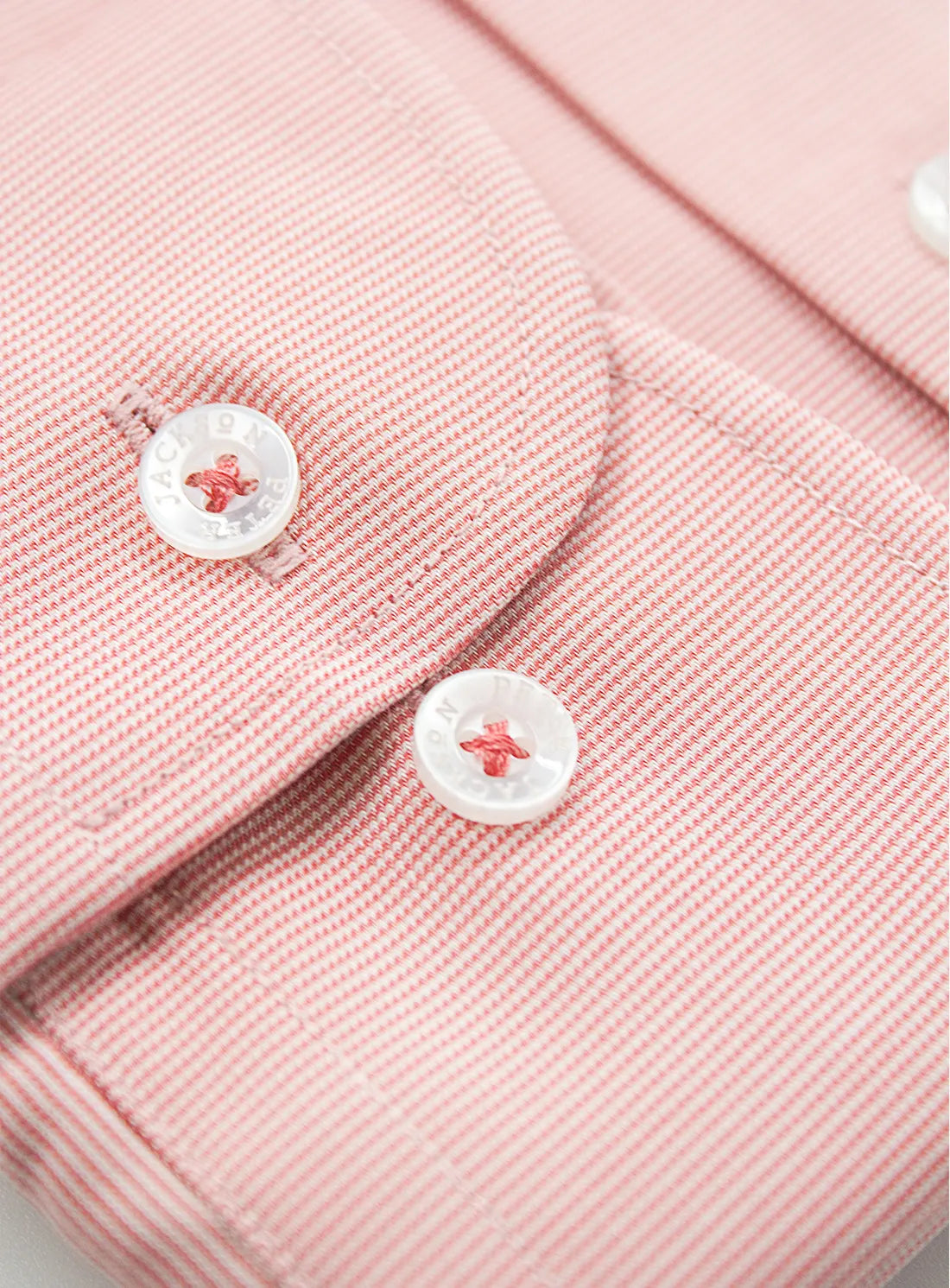 Orange dress shirt with a Peter Jackson label on a white background