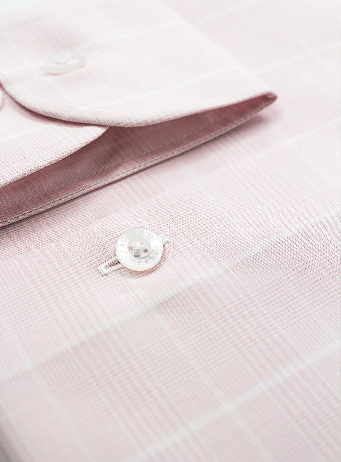 Pink dress shirt with a Peter Jackson label on a white background