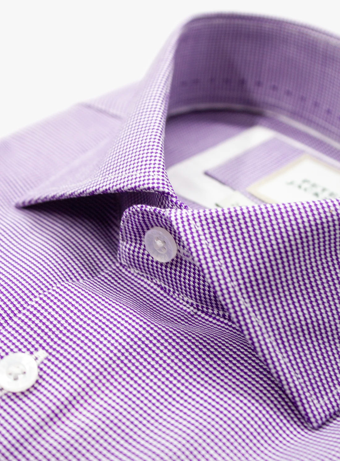 Close-up of a purple checkered shirt with a collar and buttons.