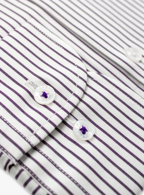 Close-up of a striped shirt with buttons and a brand label.