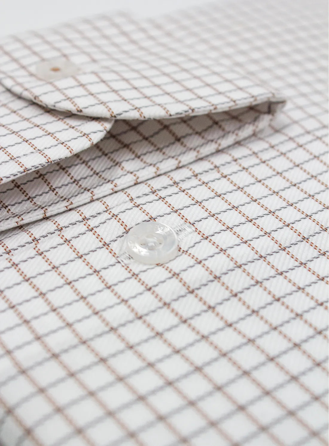 Close-up of a checkered fabric with water droplet on a white background