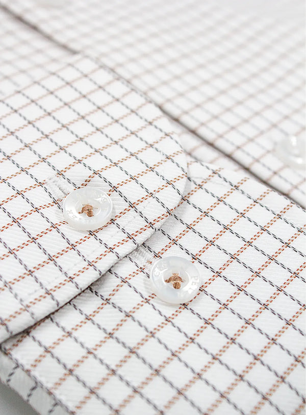 Close-up of a textured fabric with a grid pattern and two buttons.
