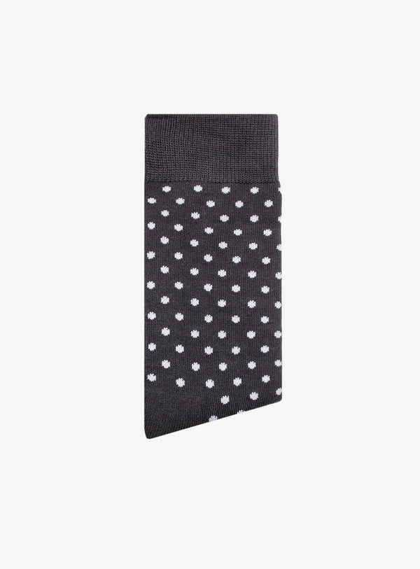 Black sock with white polka dots on a white background