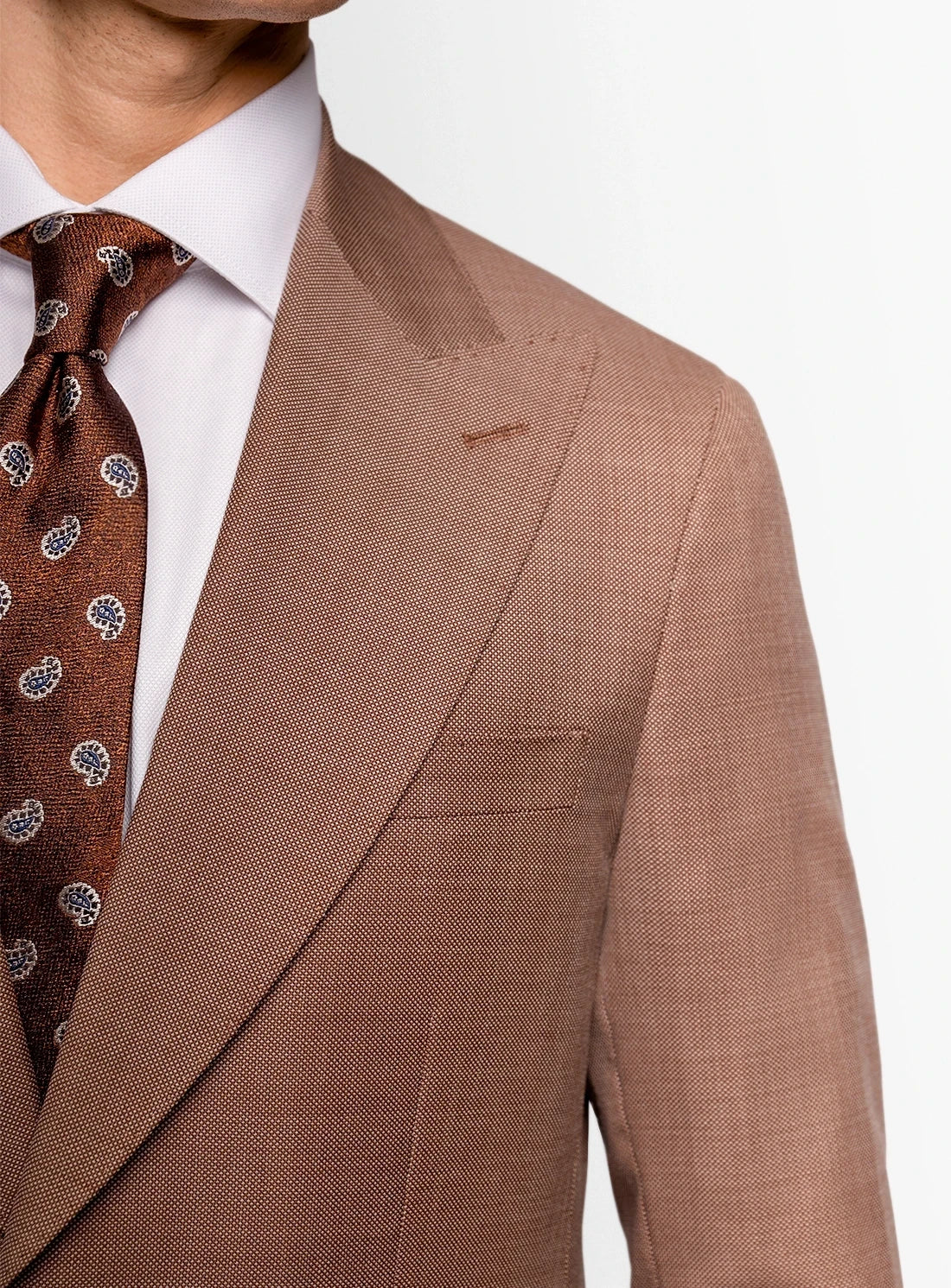 Brown suit jacket with a patterned tie on a white background