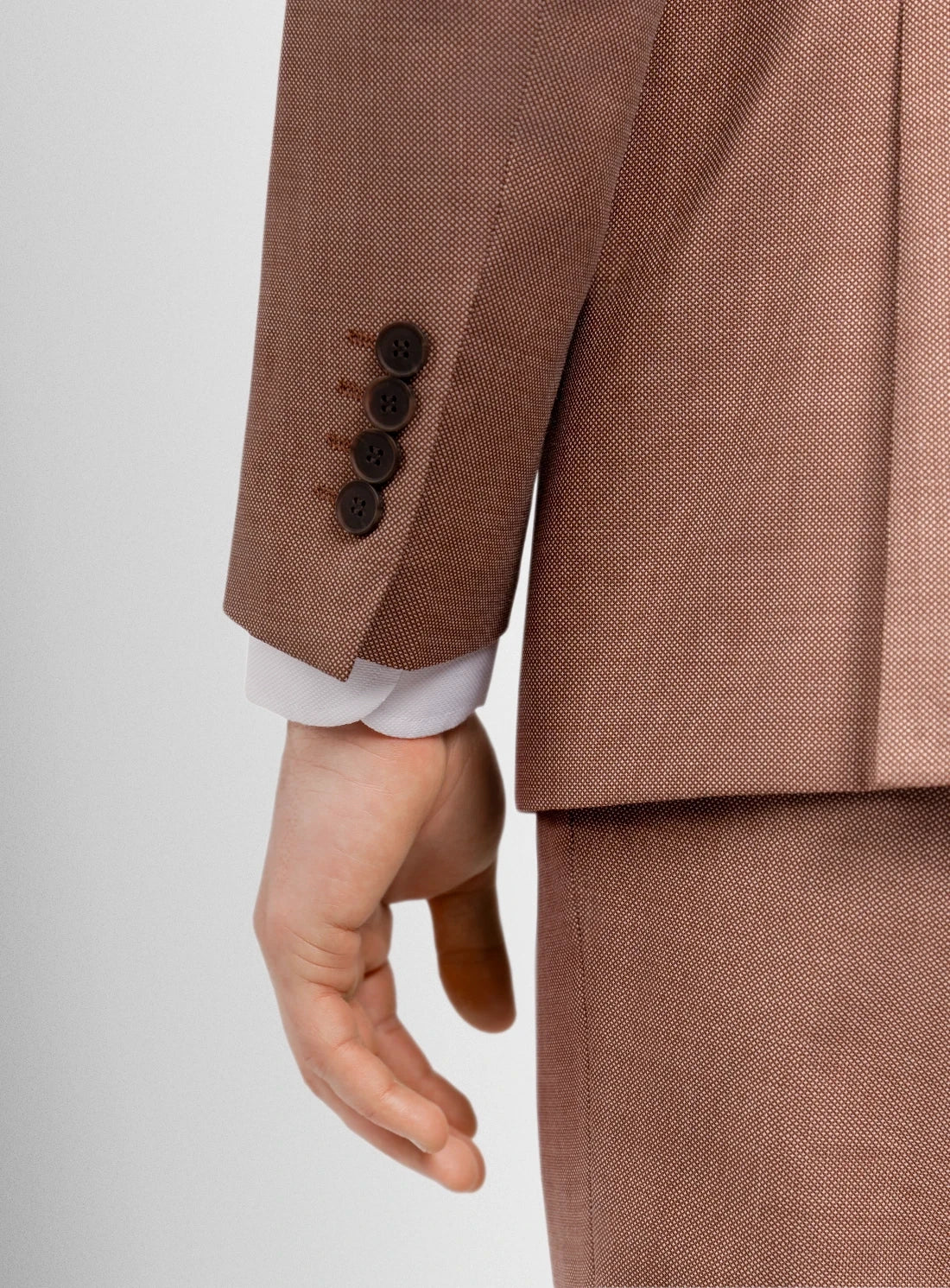 Brown suit jacket with three buttons on a white background