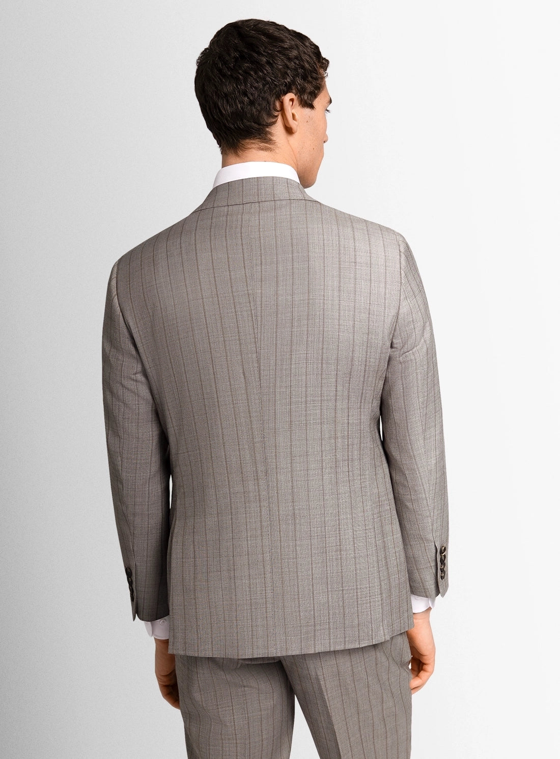 Man wearing a gray checkered suit on a white background