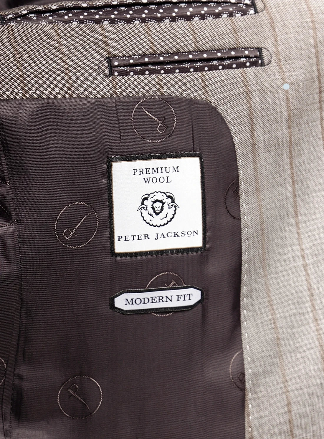 Close-up of a suit label with 'Peter Jackson' branding on premium wool fabric.