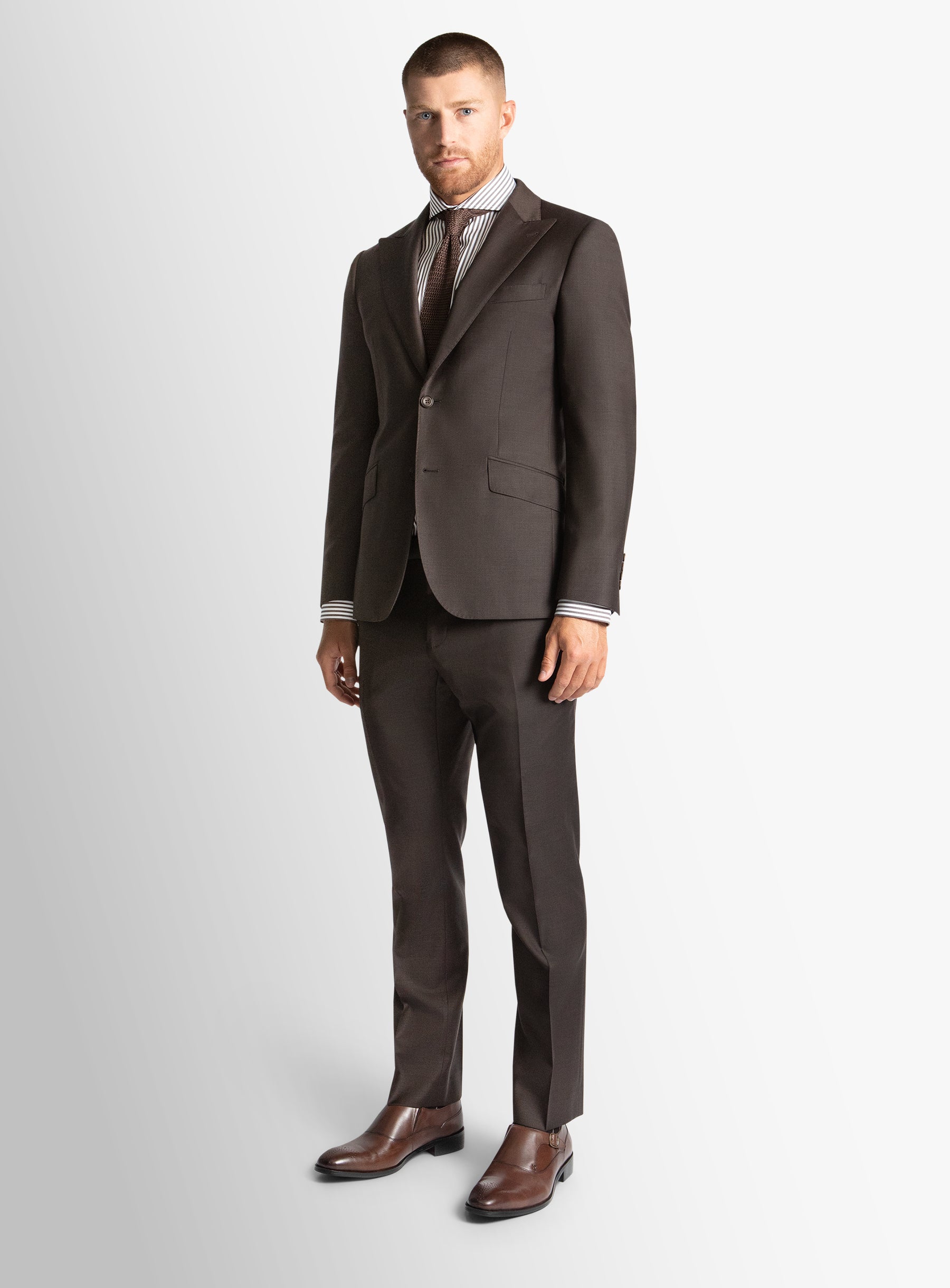 Man wearing a brown suit on a white background