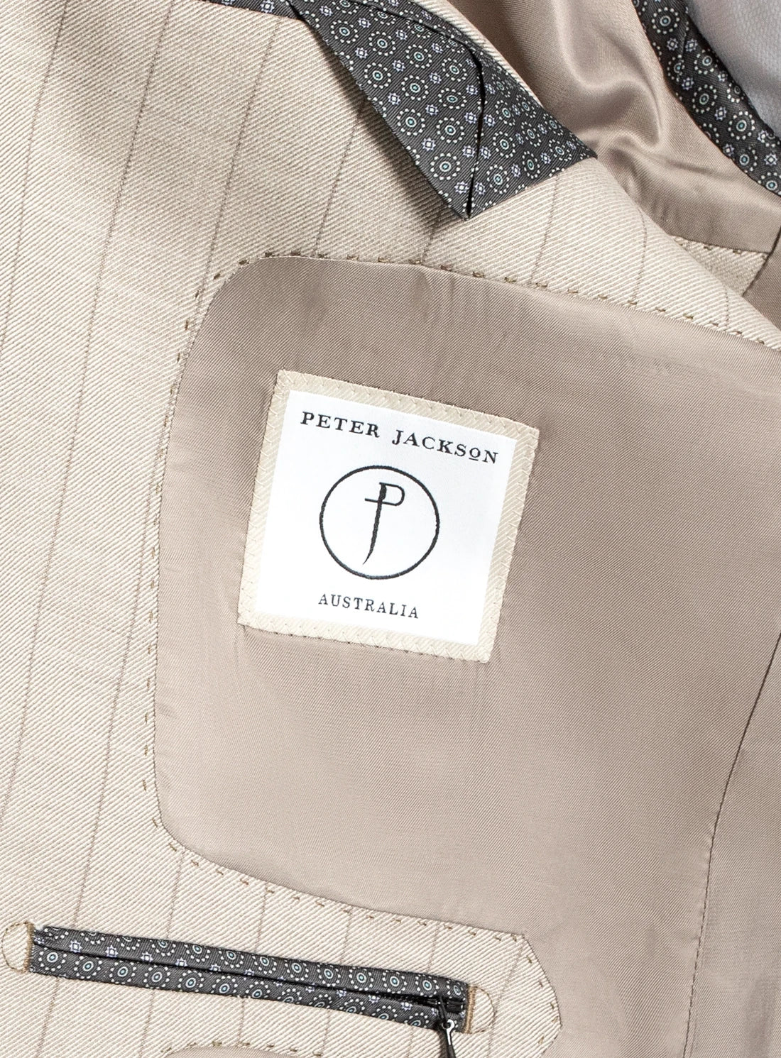 Close-up of a beige fabric with a Peter Jackson Australia label.