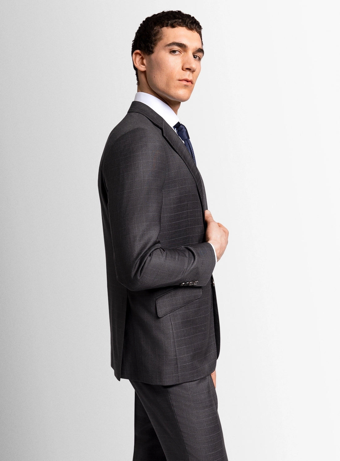 Man wearing a gray suit on a light gray background