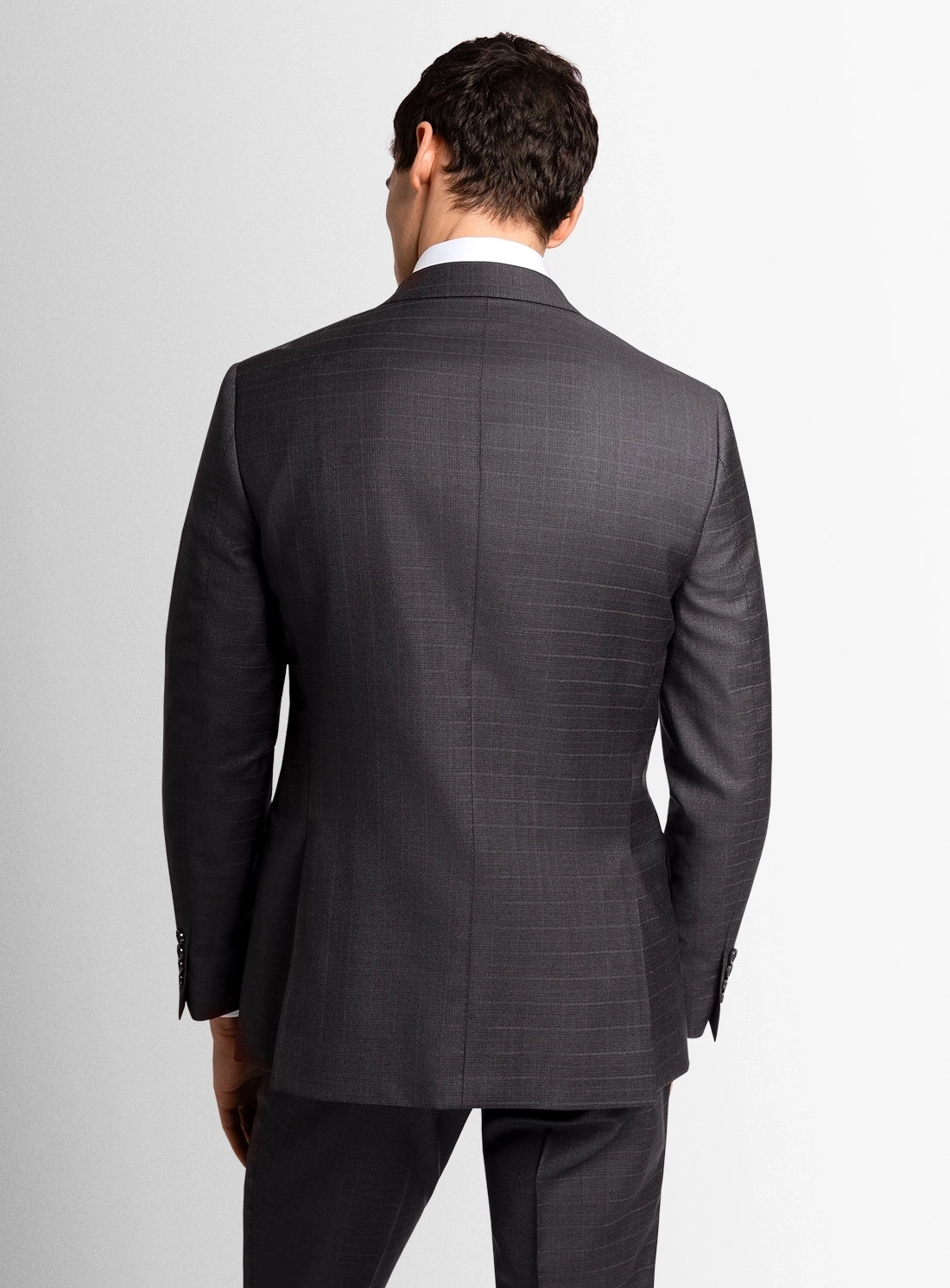 Man wearing a gray suit on a plain background