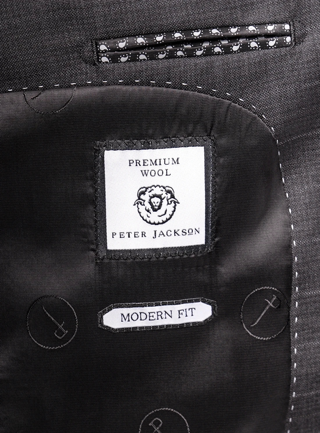 Close-up of a suit label with 'Peter Jackson' branding on premium wool fabric.
