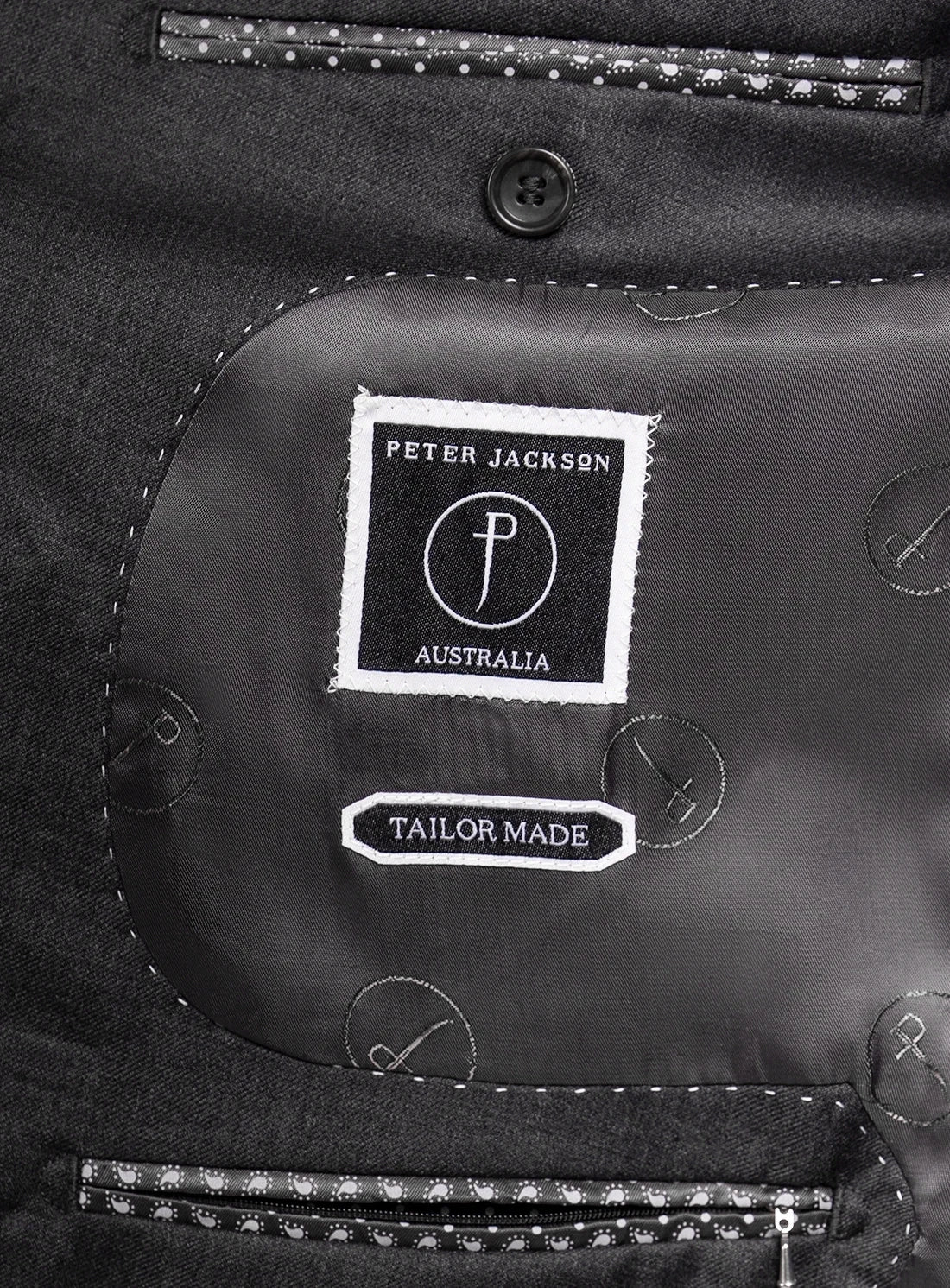 Close-up of a 'Peter Jackson Australia' tailor-made label on a black garment.