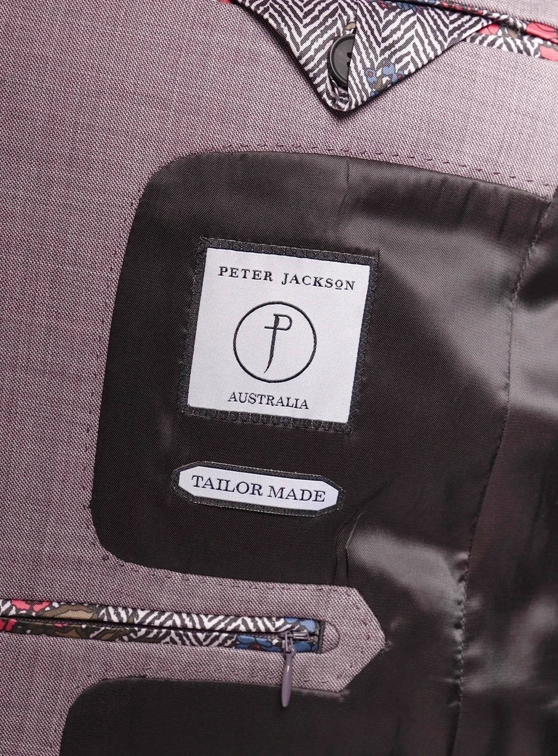 Close-up of a suit with a Peter Jackson Australia label on the chest pocket.