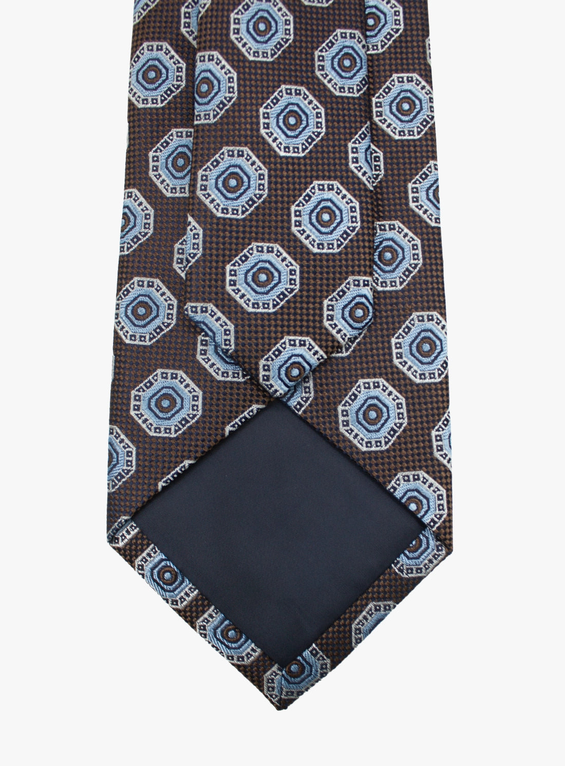 Patterned tie with a matching pocket square on a white background