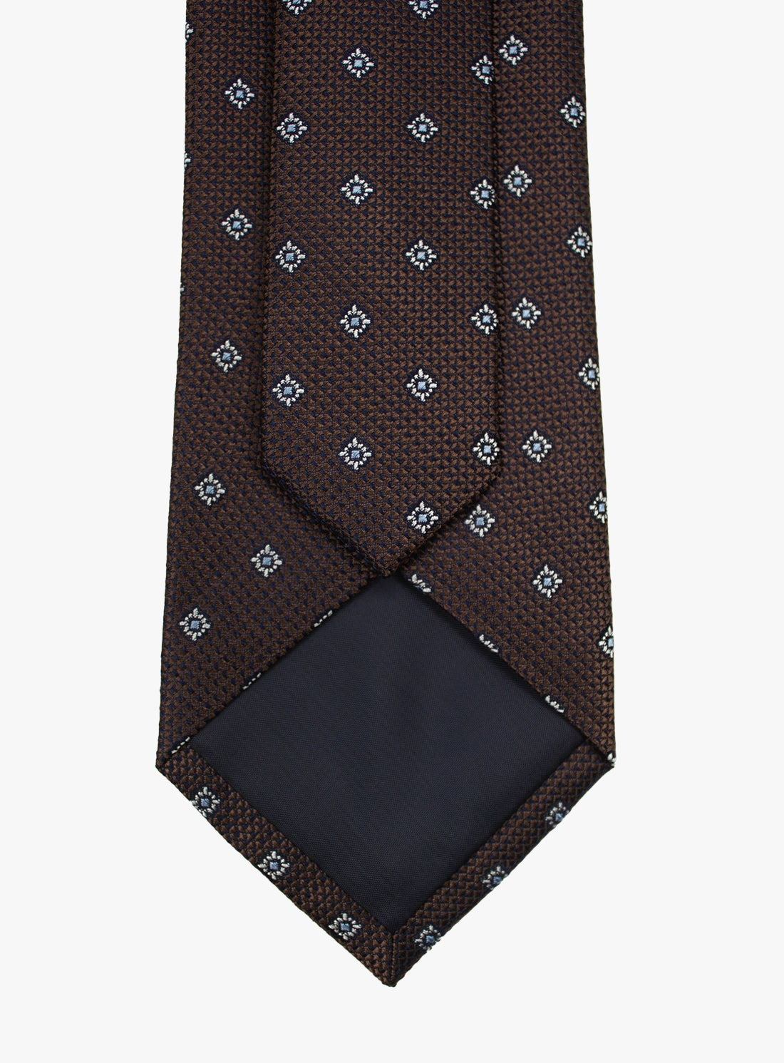 Brown patterned tie with a matching pocket square on a white background