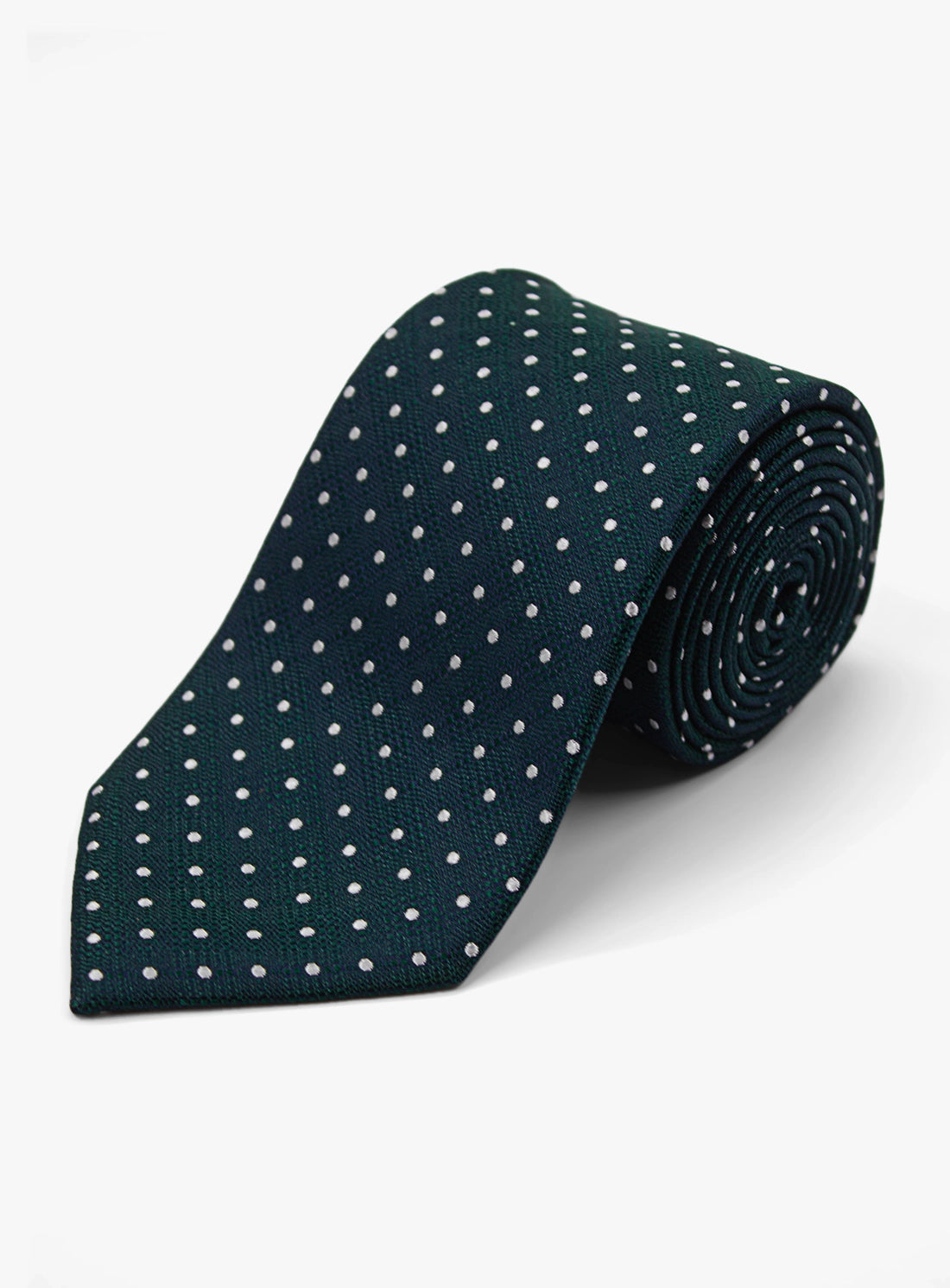 Green tie with white polka dots on a light gray background
