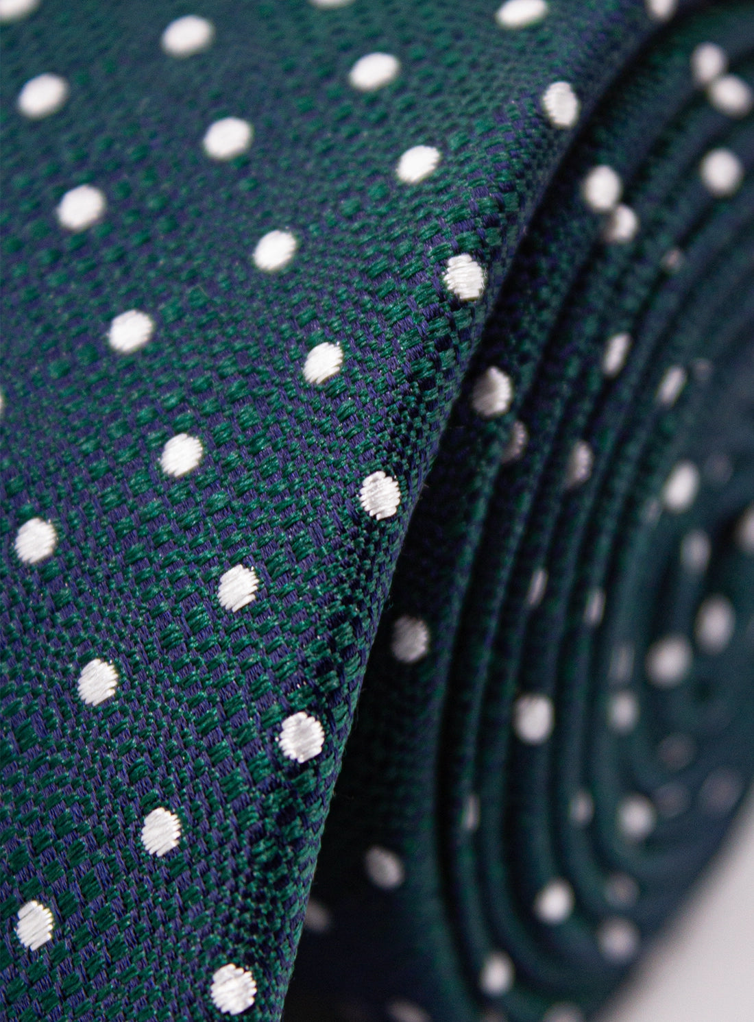 Close-up of a green tie with white polka dots