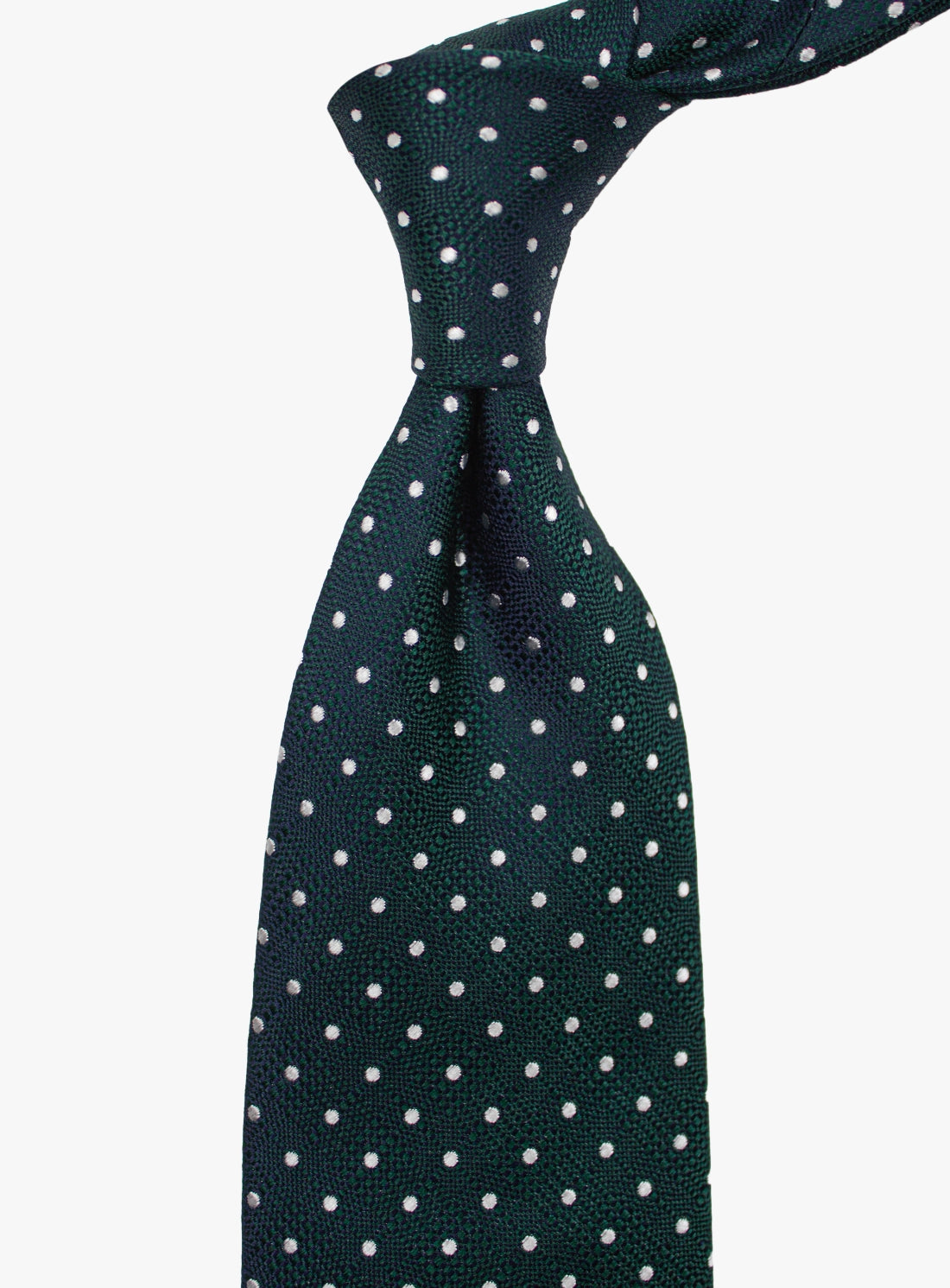 Green tie with white polka dots on a white background