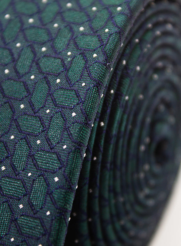 Close-up of green fabric with a subtle pattern on a white background