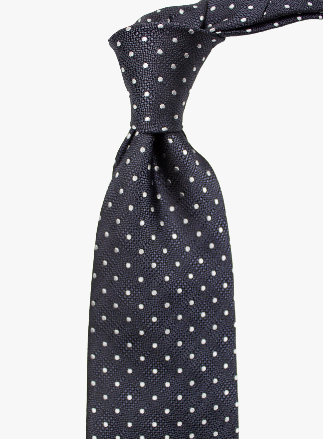 Navy blue tie with white polka dots on a white background
