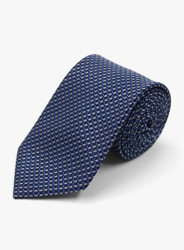 Folded blue patterned tie on a white background