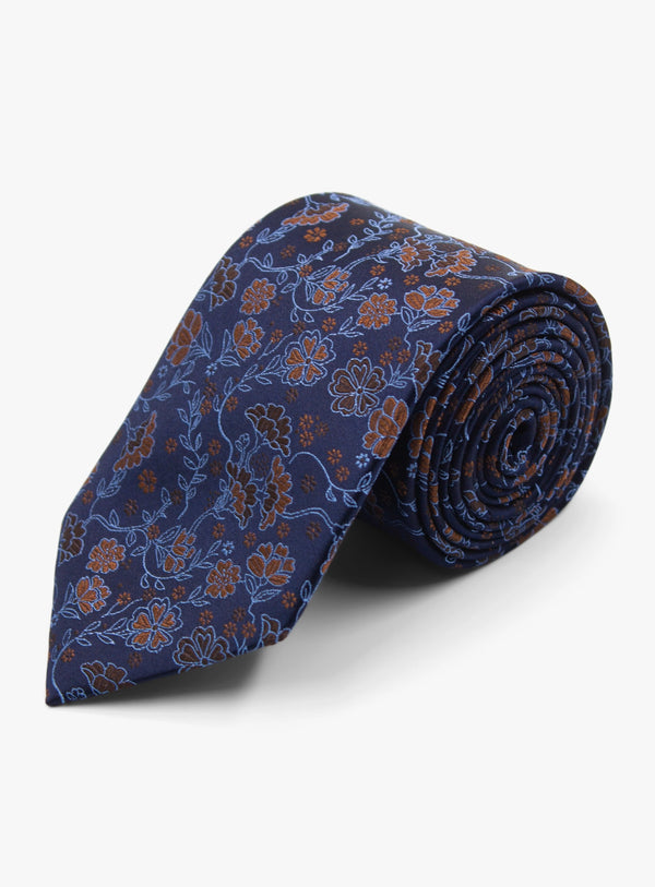 Roll of blue floral patterned tie on a white background