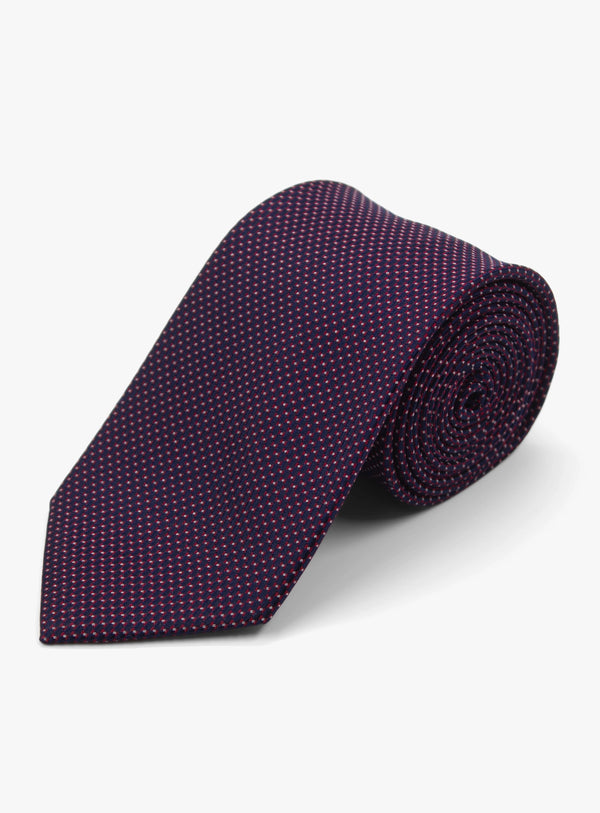 Purple patterned tie on a light gray background