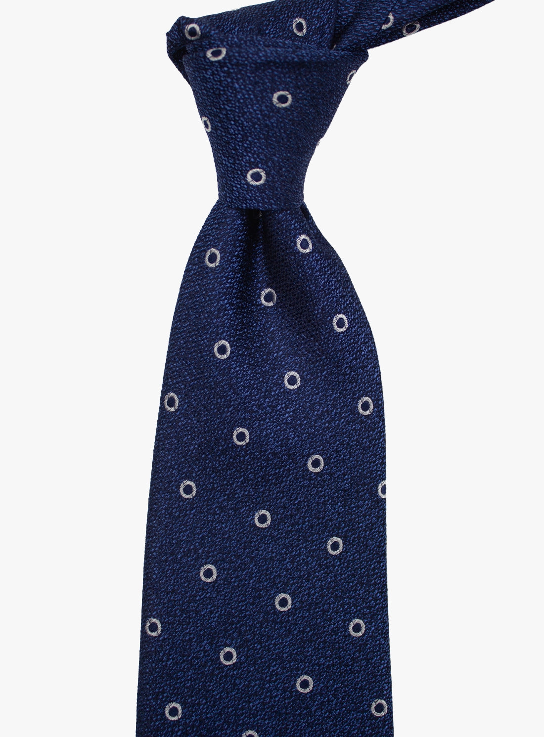 Navy blue tie with white circular pattern on a white background