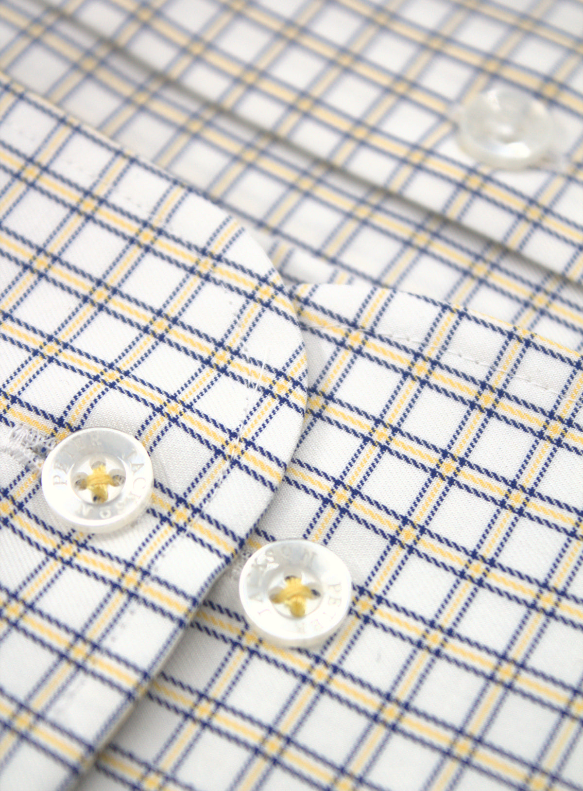 Adjustable two-button cuff detail on Milan yellow and navy mini plaid shirt