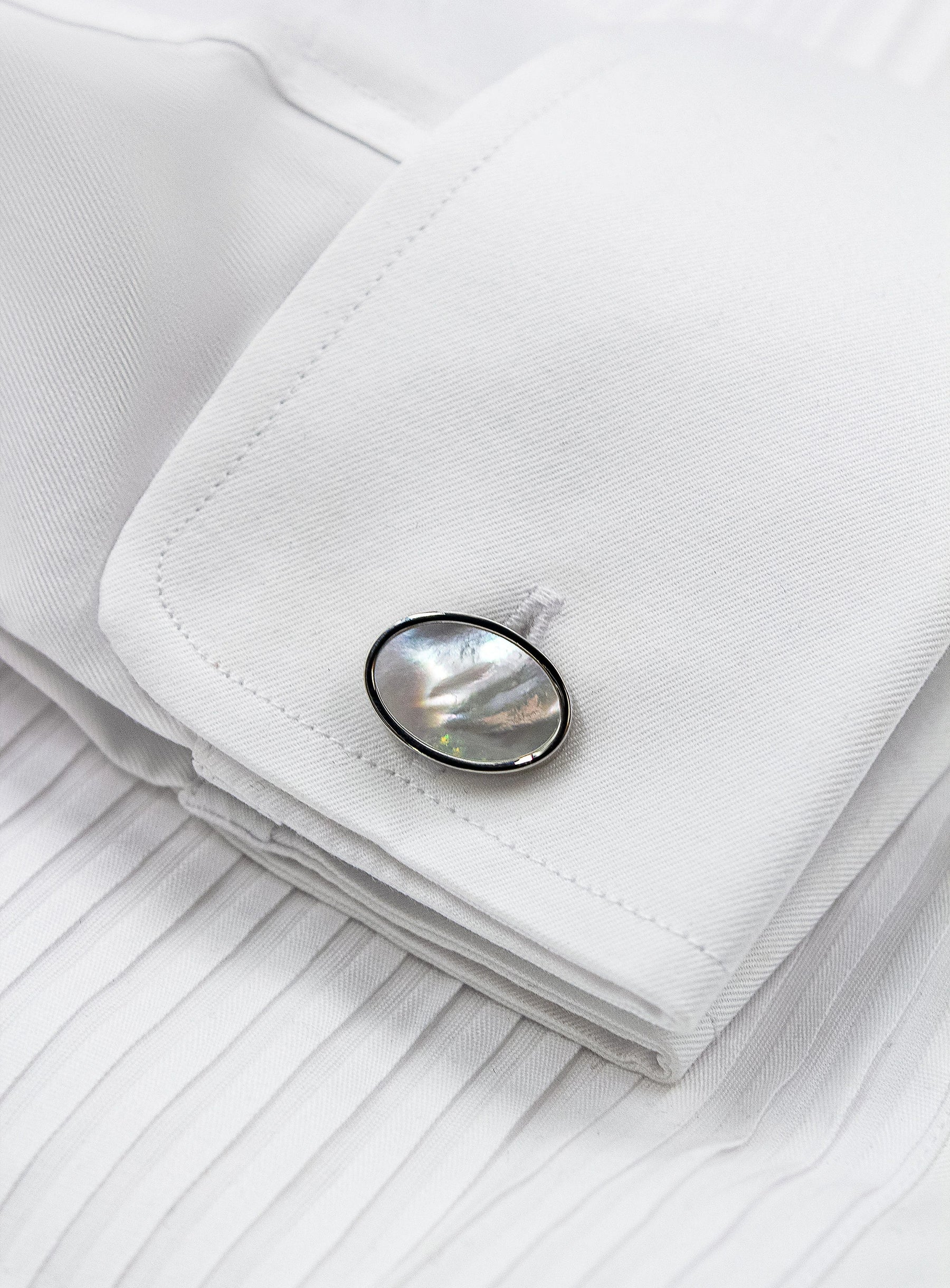 oval silver with mother of pearl cufflinks in shirt