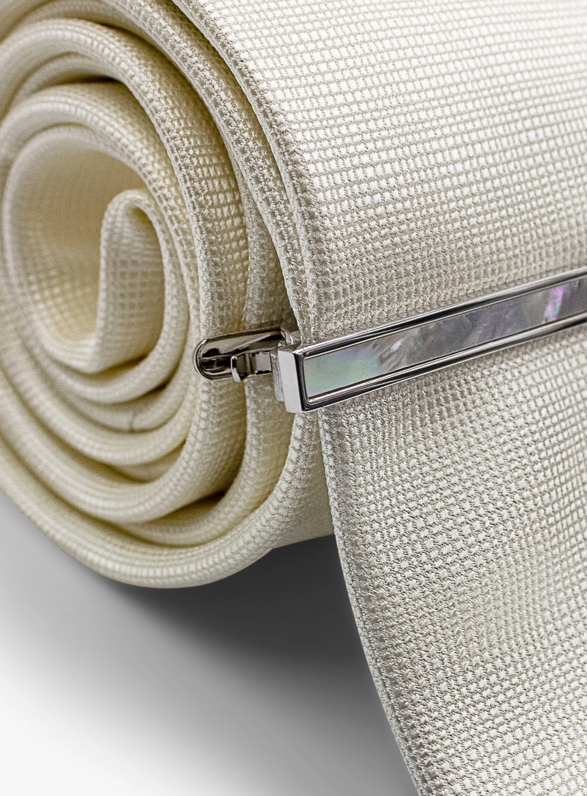 silver with mother of pearl tie bar on tie