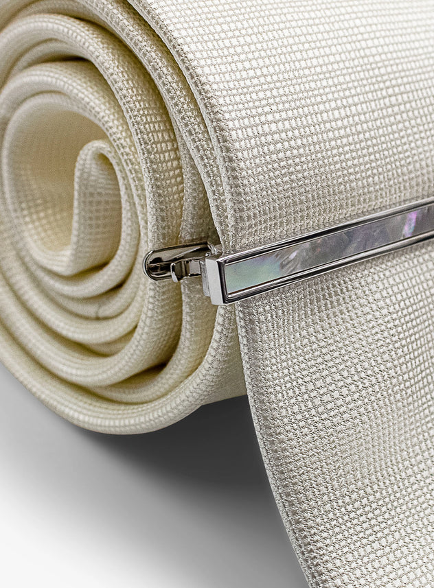 silver with mother of pearl tie bar on tie
